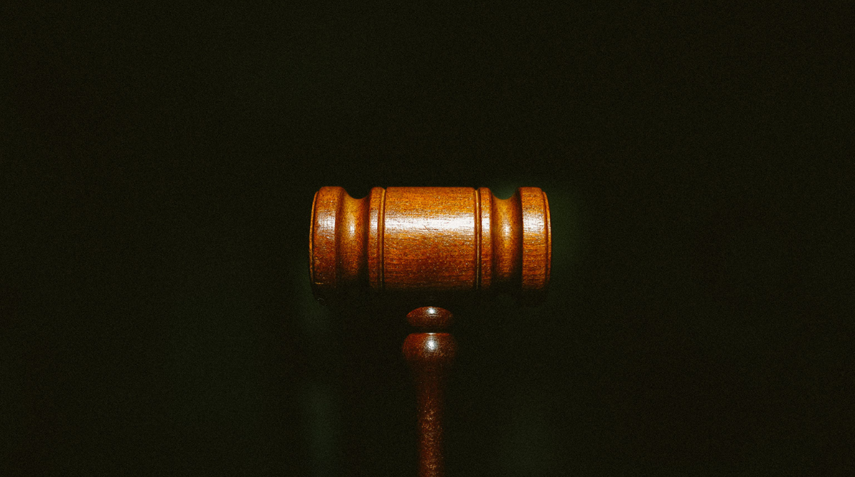 A gavel against a black background.